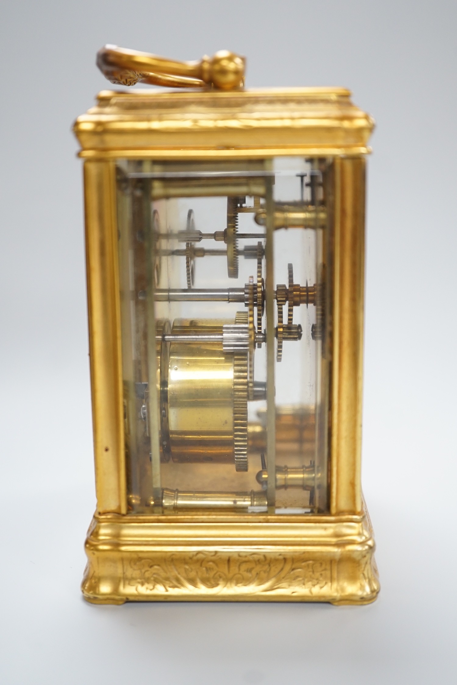 A late 19th century French eight day timepiece, in an engraved brass gorge case. 12cm tall